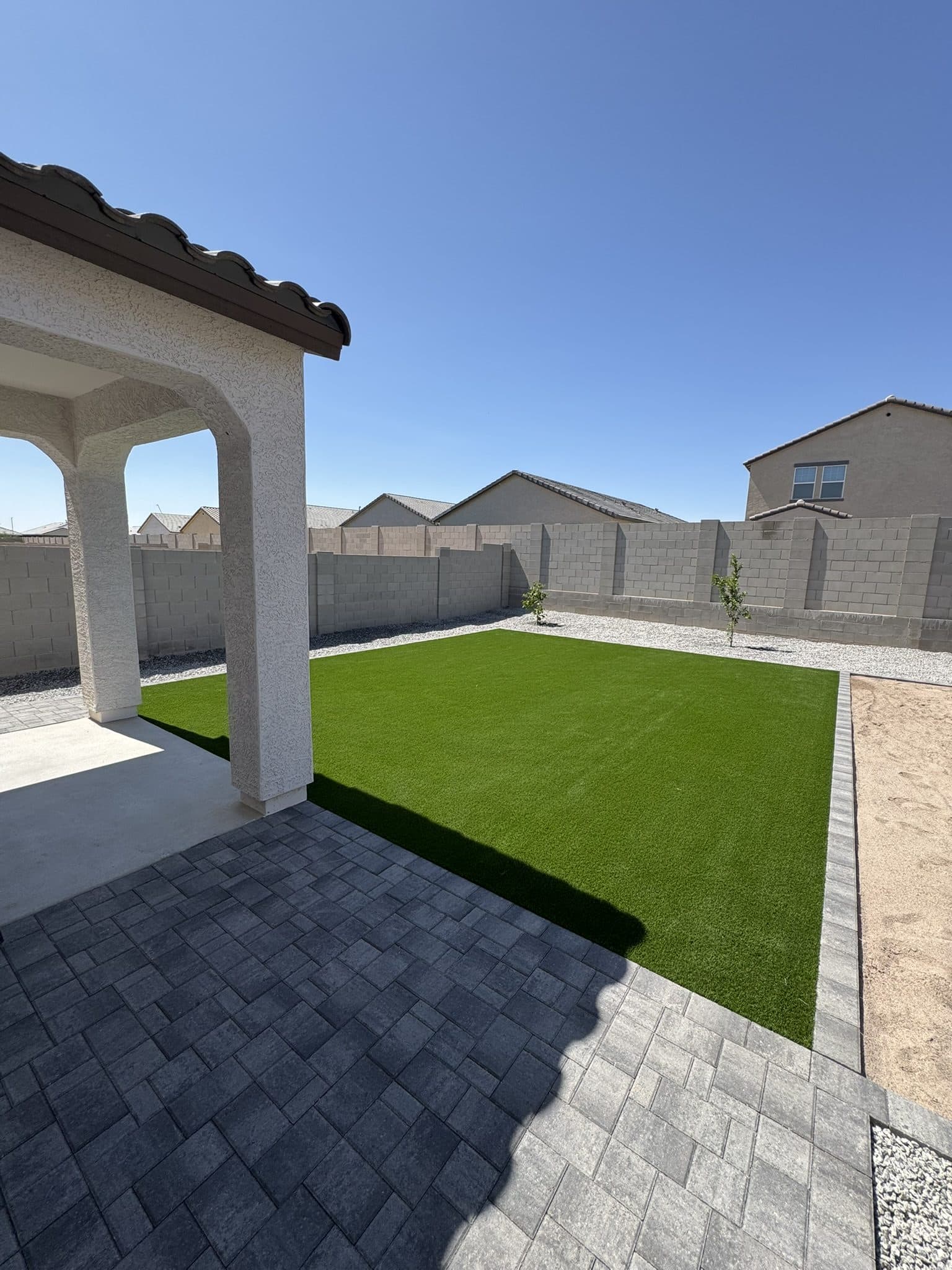 Turf lawn, Townscape Slate paver patio and a beach sand pit
