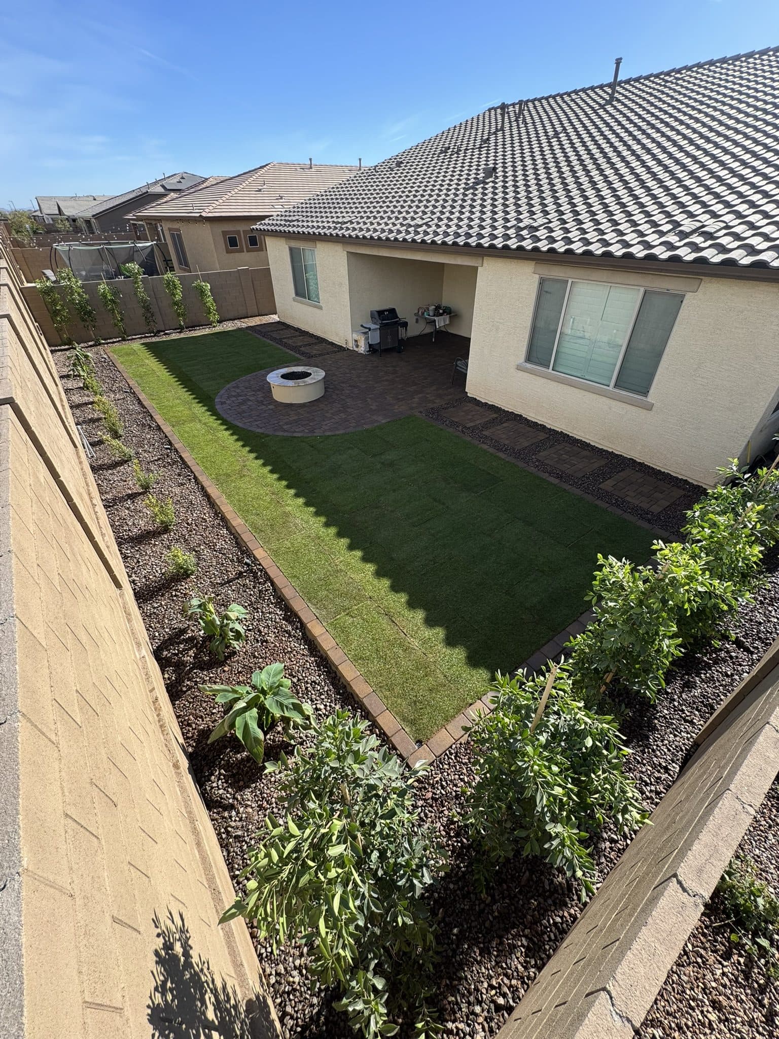 Tahoma 31 sod lawn, Territorial Phoenix Pavers and a round gas fire pit