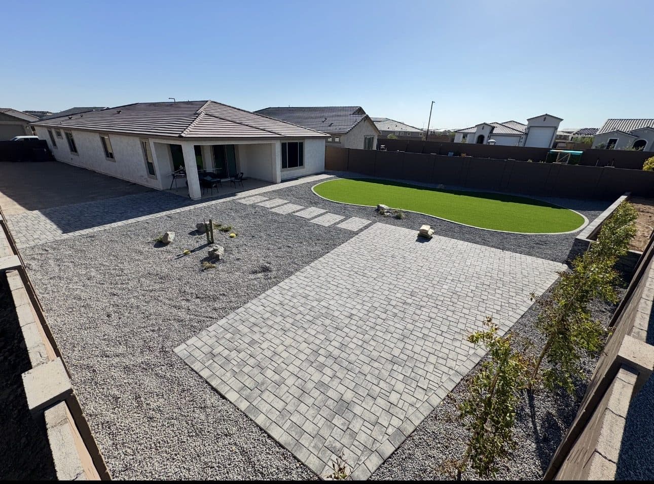 Townscape Slate paver patio, charcoal rock and plants in a Surprise backyard